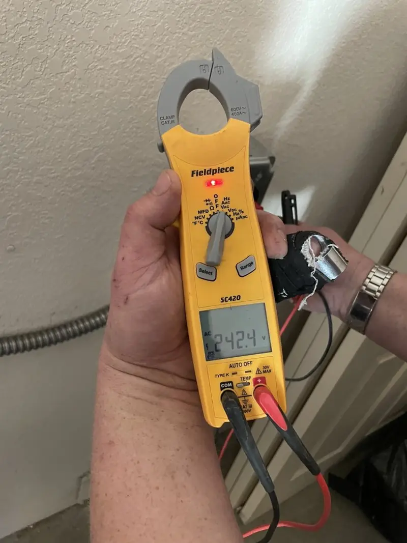 Voltage testing with clamp meter during Ceiling Fan Installation in University Center